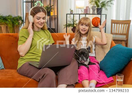 Mother daughter dog wireless headphones lo fi music work on laptop hum sing rhythm with focus family Mother daughter dog wireless headphones lo fi music work on laptop hum sing rhythm with focus family 134799233
