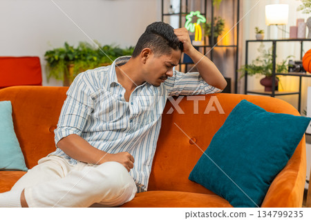Indian man tired and bad mood after hard day stress fatigue burnout needs rest quiet time and calm Indian man tired and bad mood after hard day stress fatigue burnout needs rest quiet time and calm 134799235