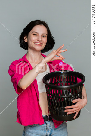 Young woman smiling removing eyeglasses throwing them away symbolizing vision correction and freedom 134799331