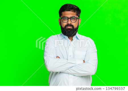 Indian man crossing arms looking strict showing authority confidence discipline serious emotion Indian man crossing arms looking strict showing authority confidence discipline serious emotion 134799337