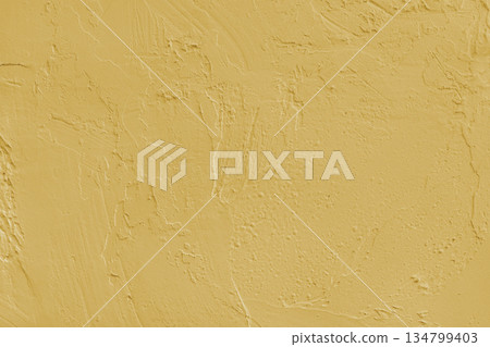 Close up yellow colored painted plaster wall surface background with rough brushstrokes texture Close up yellow colored painted plaster wall surface background with rough brushstrokes texture 134799403