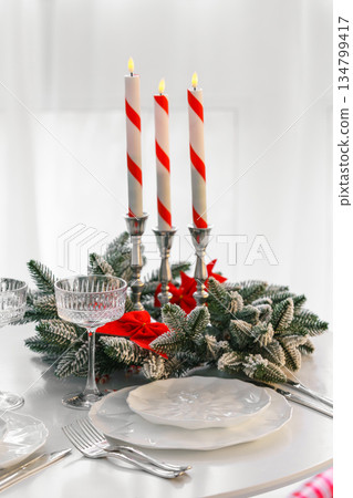 Elegant crystal tall glass with festive evergreen decor for Christmas holiday dinner Elegant crystal tall glass with festive evergreen decor for Christmas holiday dinner 134799417