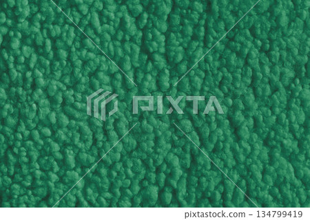Green color soft faux fur cloth texture with fluffy plush surface for cozy fabric backgrounds 134799419