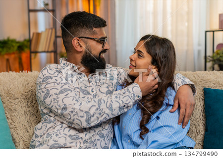 Indian family couple man woman touching face and looking at each other with love and tenderness Indian family couple man woman touching face and looking at each other with love and tenderness 134799490