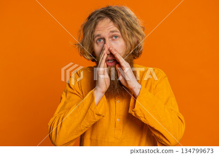Caucasian young man whisper news rumors holding hands near mouth share gossip quiet keep my secrets 134799673
