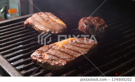 Steakhouse. Steaks are roasted on a Josper oven. Frying a steak on a josper. Steakhouse. Steaks are roasted on a Josper oven. Frying a steak on a josper. 134800202