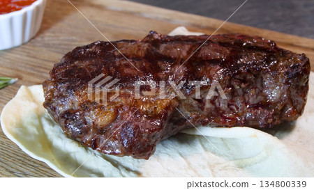 Steakhouse. Steaks are roasted on a Josper oven. The chef serves steaks on wooden boards 134800339