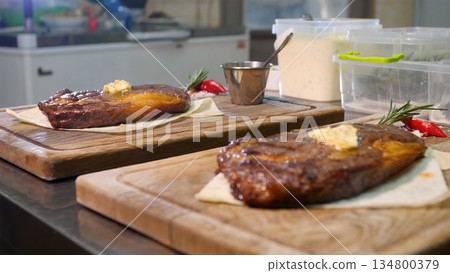 Steakhouse. Steaks are roasted on a Josper oven. The chef serves steaks on wooden boards 134800379