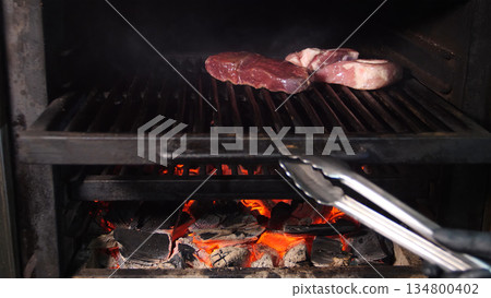 Steakhouse. Steaks are roasted on a Josper oven. Frying a steak on a josper. 134800402