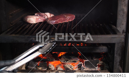 Steakhouse. Steaks are roasted on a Josper oven. Frying a steak on a josper. 134800411