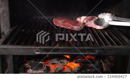 Steakhouse. Steaks are roasted on a Josper oven. Frying a steak on a josper. 134800427