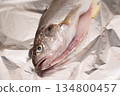 The gills and innards of the Ishimochi fish are removed and it is baked in foil. 134800457