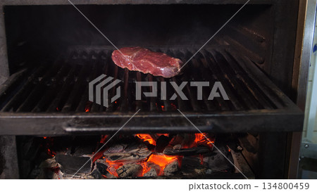 Steakhouse. Steaks are roasted on a Josper oven. Frying a steak on a josper. 134800459