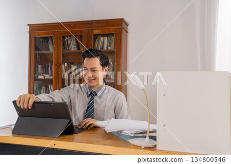 Finance specialist arranges documents on clean desk environment Finance specialist arranges documents on clean desk environment 134800546
