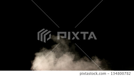 Realistic smoke effect drifting and spreading in freeze motion against a black background. Cinematic atmospheric fog ideal for VFX compositing, overlays, transitions, and moody visual effects. 134800782