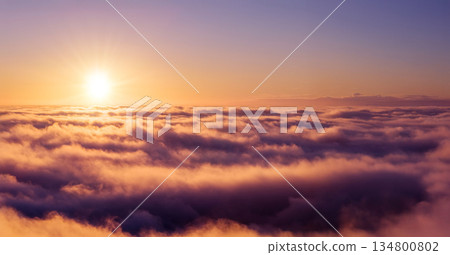 Golden sunrise above a sea of clouds, creating a calm and dreamy atmosphere. Warm morning light illuminates soft cloud layers, evoking freedom, serenity, and a sense of endless space. Golden sunrise above a sea of clouds, creating a calm and dreamy atmosphere. Warm morning light illuminates soft cloud layers, evoking freedom, serenity, and a sense of endless space. 134800802