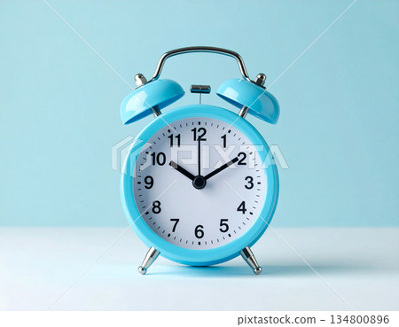 Deadline. Blue metal alarm clock with blue bells on pastel blue background. 134800896