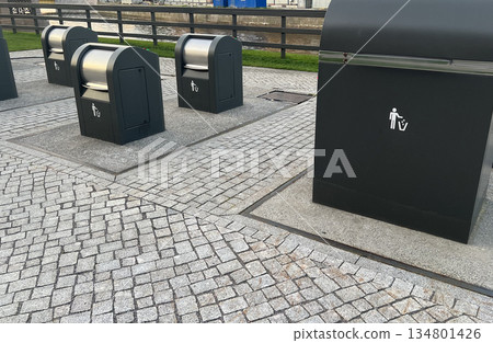 Modern garbage cans designed for separate collection of garbage in urban parks 134801426