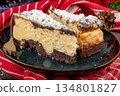 Two pieces of cheesecake. 134801827