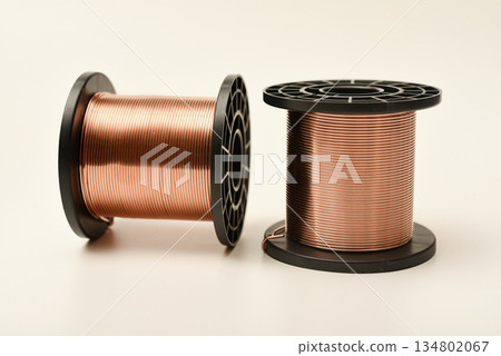 Copper coils on a white background. Copper wire for electronics. Pure copper. Copper coils on a white background. Copper wire for electronics. Pure copper. 134802067