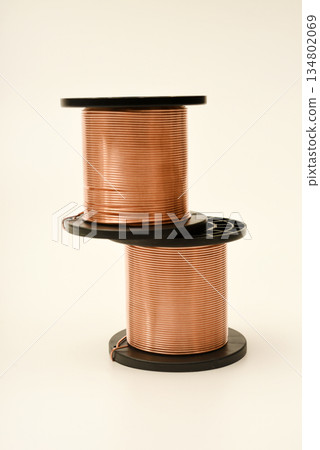 Copper coils on a white background. Copper wire for electronics. Pure copper. Copper coils on a white background. Copper wire for electronics. Pure copper. 134802069