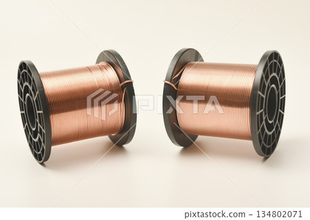 Copper coils on a white background. Copper wire for electronics. Pure copper. Copper coils on a white background. Copper wire for electronics. Pure copper. 134802071