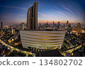 Cityscape building modern business district of Bangkok. Interchange station, sky train railway in the foreground at twilight time. 134802702