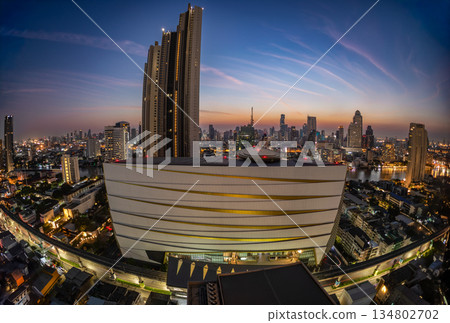 Cityscape building modern business district of Bangkok. Interchange station, sky train railway in the foreground at twilight time. Cityscape building modern business district of Bangkok. Interchange station, sky train railway in the foreground at twilight time. 134802702