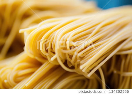 Delicious yellow pasta strands ready for cooking 134802966