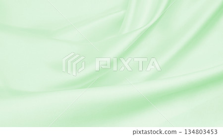 Smooth elegant green silk or satin luxury cloth texture as abstract background. Luxurious background design 134803453