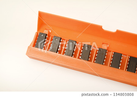 Microchips in a plastic case. Integrated circuits in a plastic storage case. Electronic chips. Microchips in a plastic case. Integrated circuits in a plastic storage case. Electronic chips. 134803808