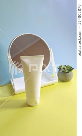 White cosmetic tube in front of mirror White cosmetic tube in front of mirror 134803876