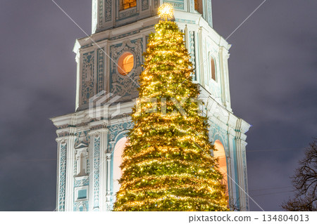 Kyiv Ukraine The main Christmas tree of the country near St. Sophia Cathedral, 11th century. Christmas lights at night sky. Bell tower. 25 December 2025 134804013