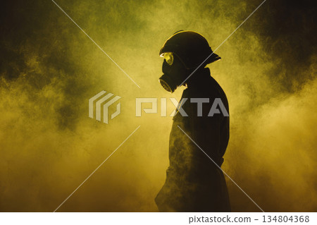 Cbrn soldier wearing gas mask stands in dense yellow smoke with protective helmet and uniform, creating dramatic and intense atmosphere for hazardous environment 134804368