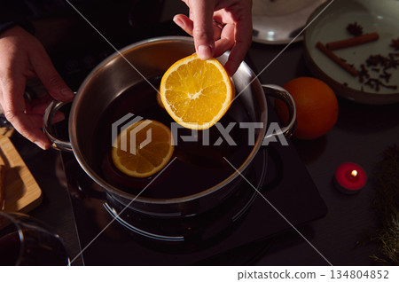 Cozy Winter Mulled Wine Preparation With Orange Slices And Spices On Stove 134804852
