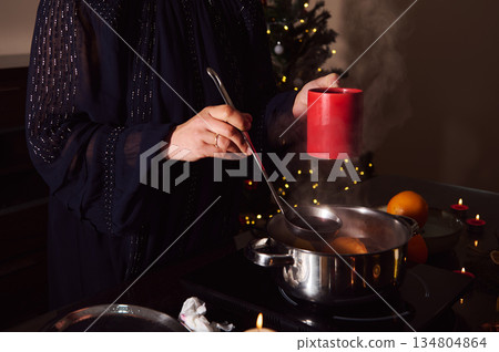 Elegant Woman In Evening Gown Preparing Mulled Wine By Candlelight Winter Holiday Scene Elegant Woman In Evening Gown Preparing Mulled Wine By Candlelight Winter Holiday Scene 134804864