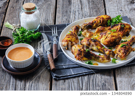 roasted chicken drumsticks on a white plate roasted chicken drumsticks on a white plate 134804890