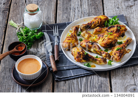 roasted chicken drumsticks on a white plate 134804891