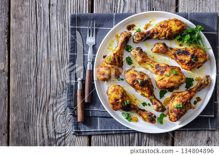 roasted chicken drumsticks on a white plate roasted chicken drumsticks on a white plate 134804896