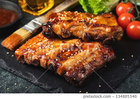 Barbecue pork spare ribs with hot honey chili marinade on black background Barbecue pork spare ribs with hot honey chili marinade on black background 134805340