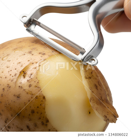 Close-up hand peeling a raw potato with a metal peeler, isolated on transparent background. Image for cooking, meal prep, and food blog content 134806022