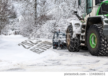 2025 Review Concept With Snowplow Clearing Winter Road In Snowy Landscape 2025 Review Concept With Snowplow Clearing Winter Road In Snowy Landscape 134806031