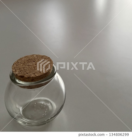 Quiet time with a white table and glass bottles Quiet time with a white table and glass bottles 134806299