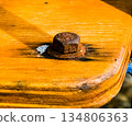 Close up of an old rusty bolt on wooden board 134806363
