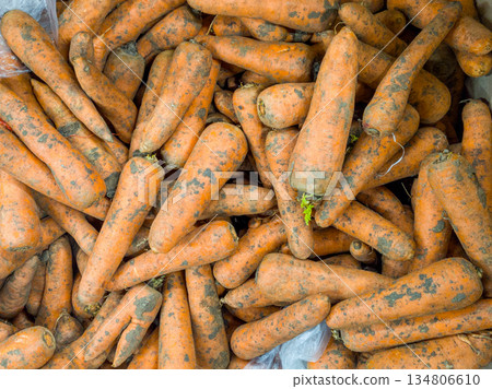 Top View of Raw Unwashed Carrots in a Supermarket Bin 134806610