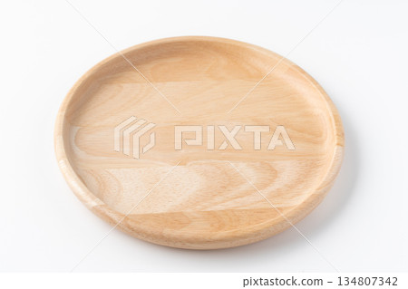 A round wooden plate on a white background 134807342