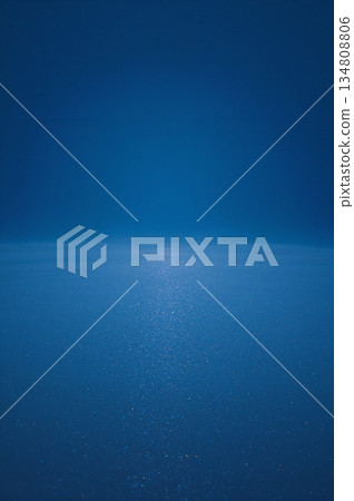 Blue ocean with a white line of light reflecting on the water 134808806