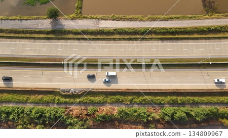 Aerial view of street in Bangkok Thailand with cars and countryside Aerial view of street in Bangkok Thailand with cars and countryside 134809967
