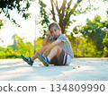 Portrait of exhausted young girl resting on the ground after sports activity. 134809990