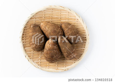 Taro (Tsuchita) on a bamboo basket on a white background Taro (Tsuchita) on a bamboo basket on a white background 134810318